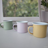 Angled Display of Pastel Yellow, Pink, and Green Enamel Mugs – Minimalist Composition, Soft Tones, Stylish Home Decor and Gift Idea 